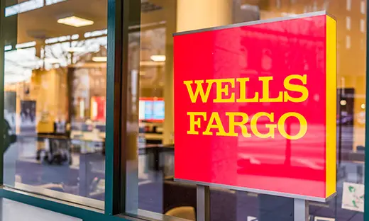 Wells Fargo bank branch exterior with illuminated company sign