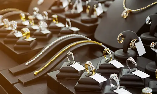 Gold and diamond rings, bracelets, and fine jewelry displayed in a retail showcase